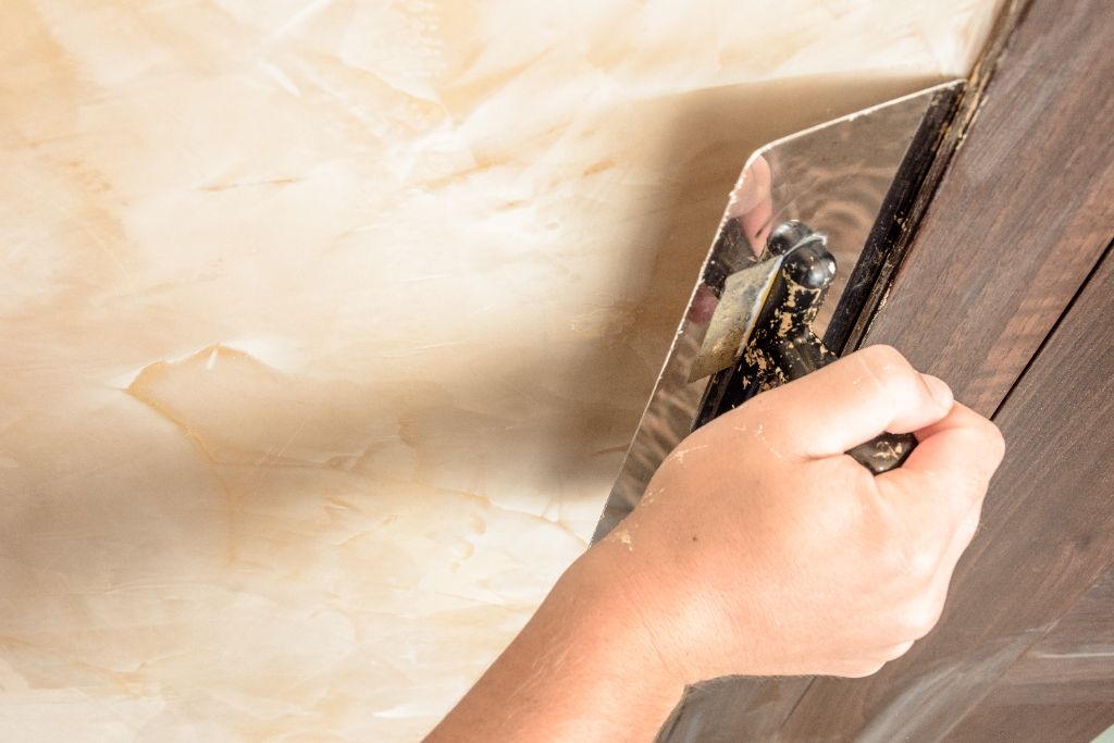 Artisan hand-troweling Venetian plaster finish